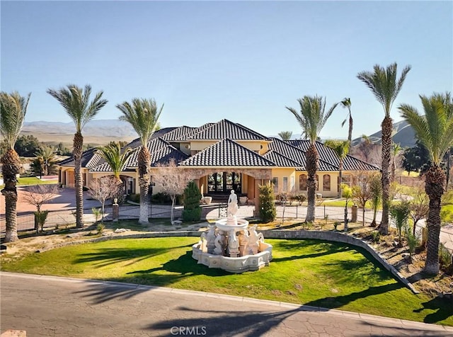 view of home's community featuring a mountain view and a lawn