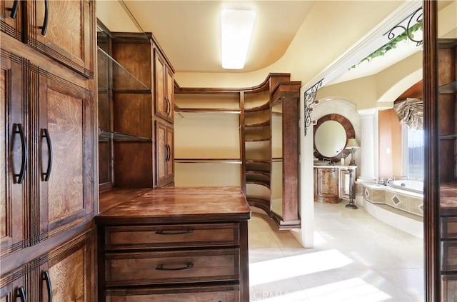 spacious closet featuring light tile patterned floors
