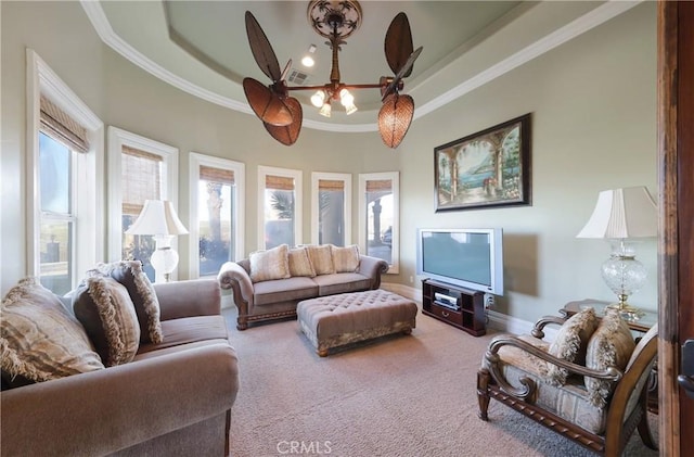 carpeted living room featuring ceiling fan, ornamental molding, and a raised ceiling