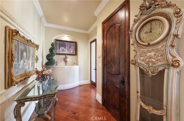 foyer with dark wood-type flooring and crown molding