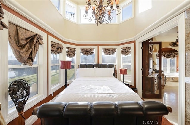bedroom with a towering ceiling and an inviting chandelier