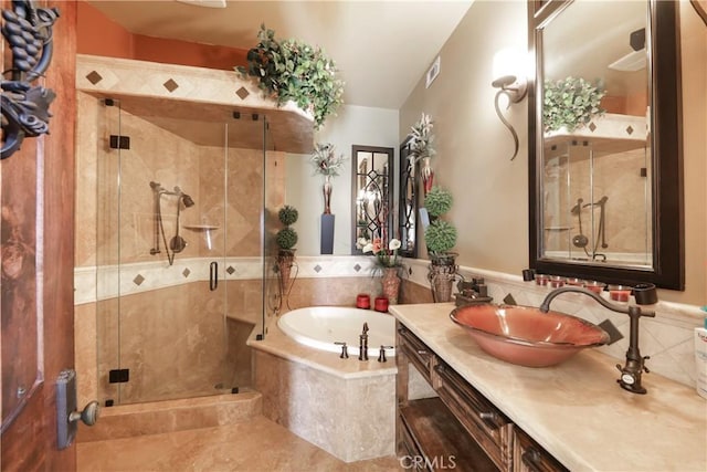bathroom featuring independent shower and bath, tile patterned flooring, and vanity