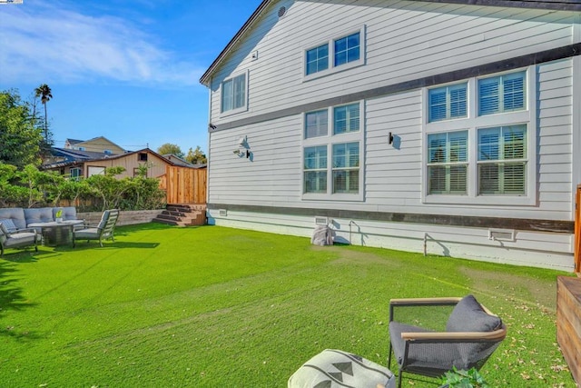 back of property with an outdoor hangout area and a yard