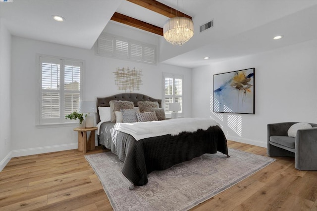 bedroom featuring multiple windows, vaulted ceiling with beams, hardwood / wood-style flooring, and an inviting chandelier