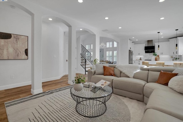 living room with sink and light hardwood / wood-style floors