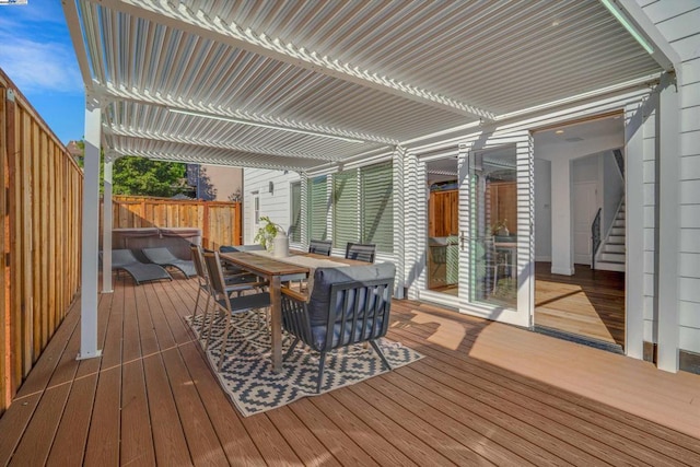 wooden terrace with a hot tub and a pergola