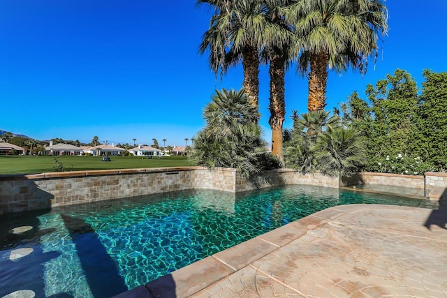 view of pool featuring a yard