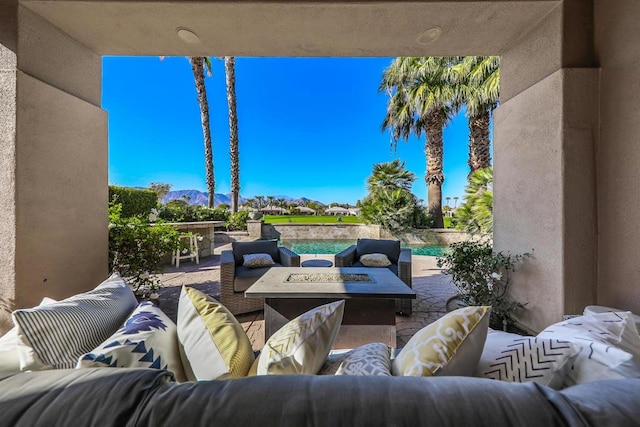 view of patio featuring an outdoor living space with a fire pit