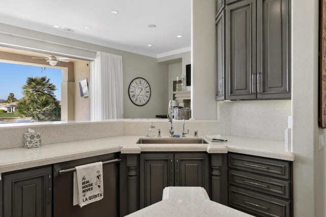 kitchen with sink, dishwasher, and ornamental molding