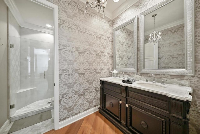 bathroom featuring a shower, ornamental molding, wood-type flooring, and vanity