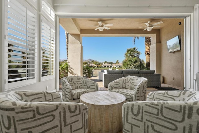 view of patio with ceiling fan and outdoor lounge area