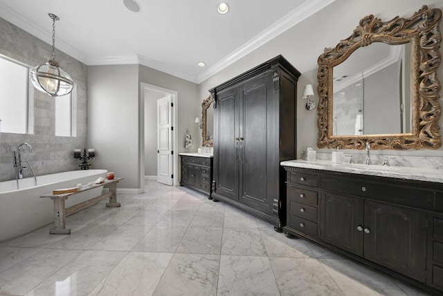 bathroom with a bathing tub, ornamental molding, and vanity