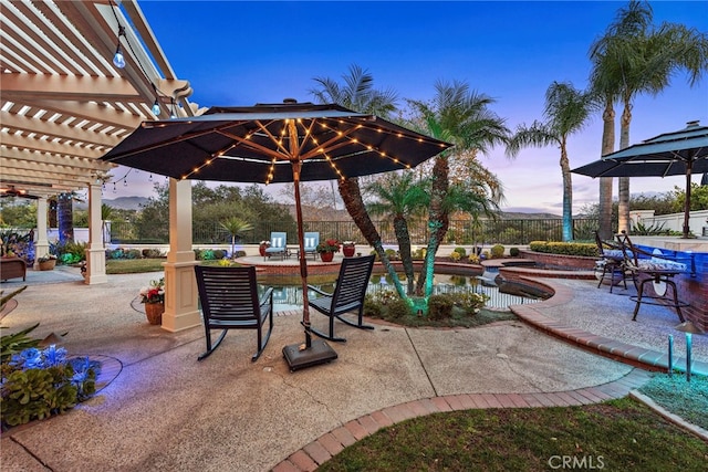 patio terrace at dusk featuring a fenced in pool and a pergola