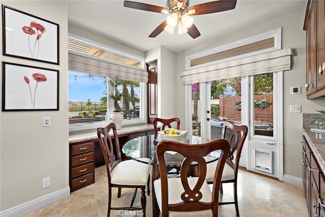 dining room featuring ceiling fan and a healthy amount of sunlight