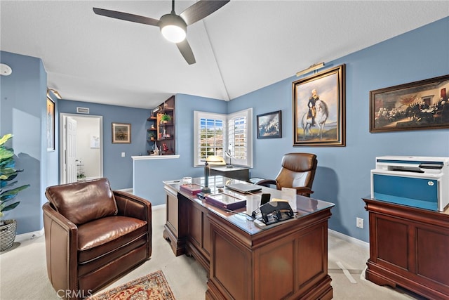 carpeted office featuring ceiling fan and lofted ceiling