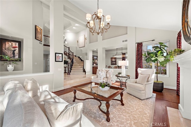 living room featuring a chandelier, hardwood / wood-style flooring, and high vaulted ceiling