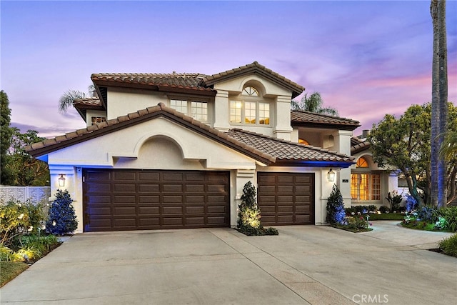 mediterranean / spanish-style house with a garage