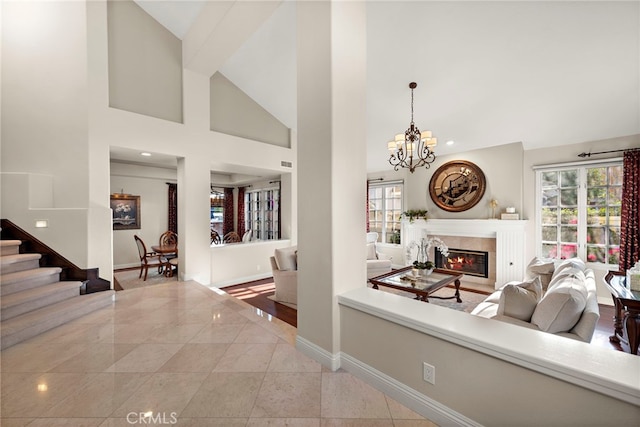 tiled living room with high vaulted ceiling and a notable chandelier