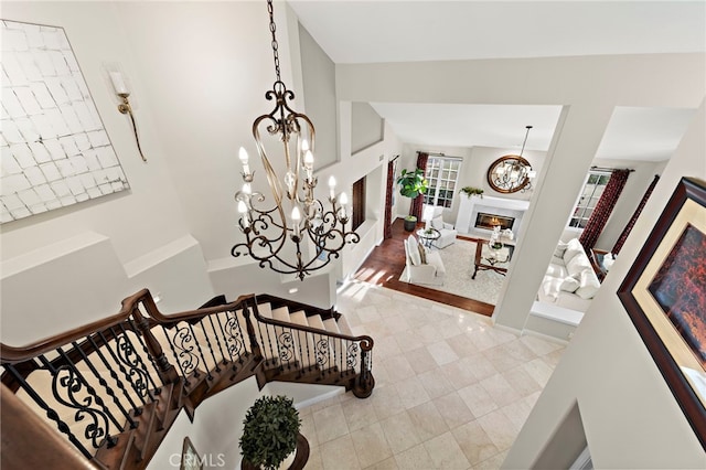 stairs featuring a chandelier and tile patterned flooring