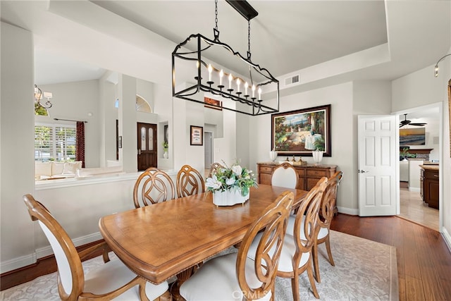 dining space featuring dark hardwood / wood-style flooring and a tray ceiling