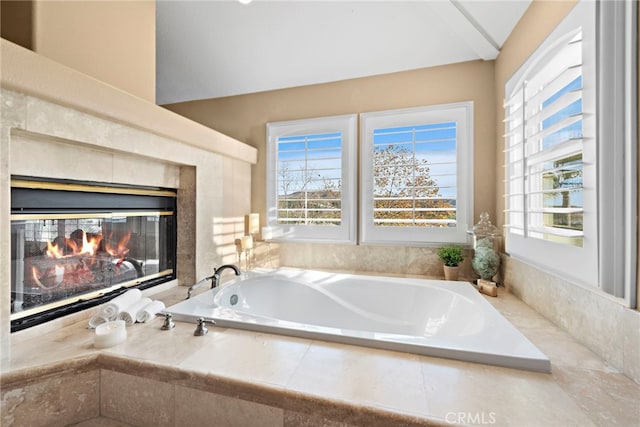 bathroom with a relaxing tiled tub