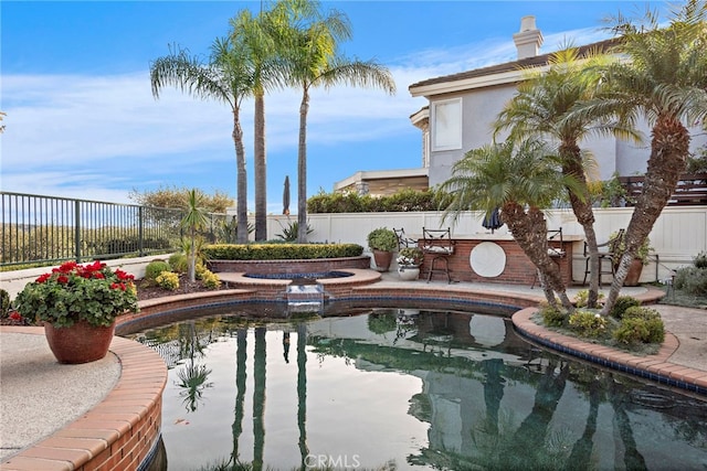 view of swimming pool featuring an in ground hot tub