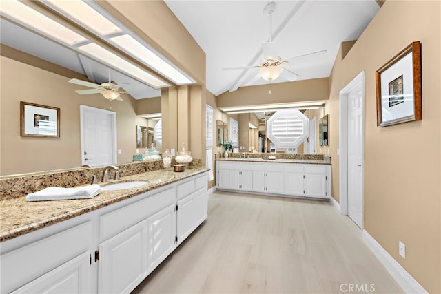 bathroom with vanity, vaulted ceiling, and ceiling fan