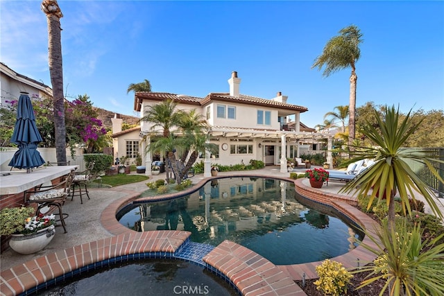 view of pool featuring a bar, a patio, and a pergola