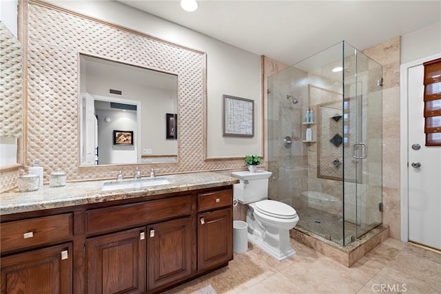 bathroom with vanity, toilet, and an enclosed shower