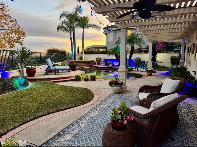 patio terrace at dusk featuring a pergola and ceiling fan