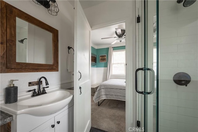 bathroom featuring ceiling fan, walk in shower, vanity, and ornamental molding