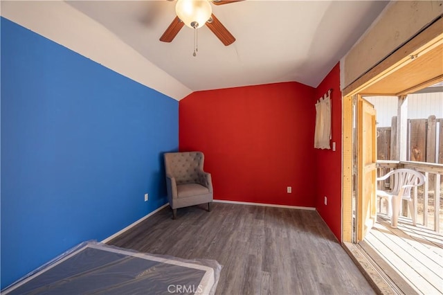 unfurnished room with vaulted ceiling, ceiling fan, plenty of natural light, and hardwood / wood-style flooring