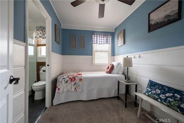 bedroom with ceiling fan, connected bathroom, carpet, and multiple windows