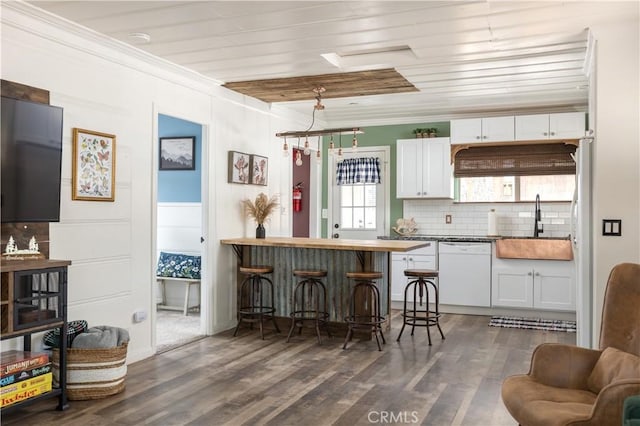 kitchen featuring white cabinetry, dishwasher, dark hardwood / wood-style flooring, and sink