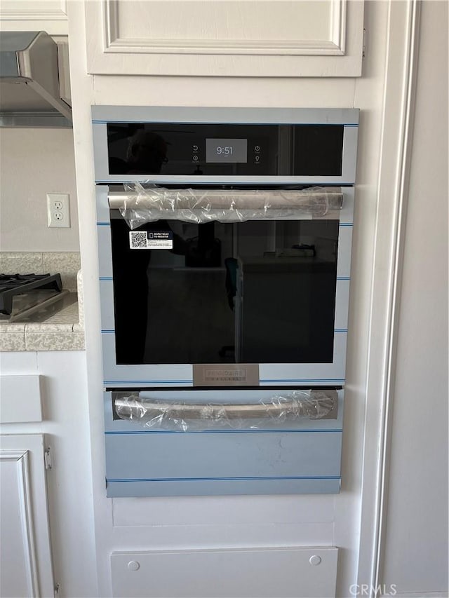 room details with gas stovetop and white cabinets