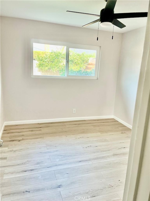 spare room featuring ceiling fan and light wood-type flooring