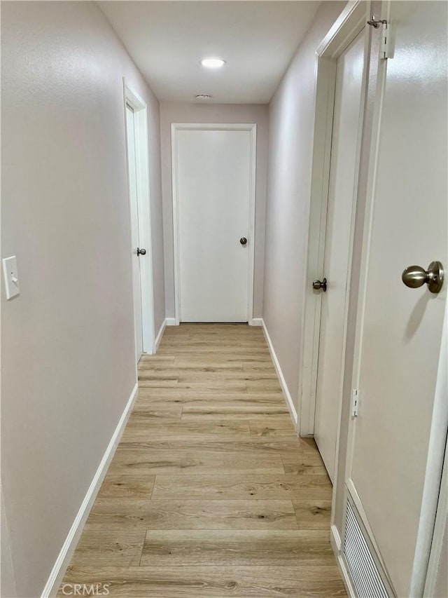 hallway with light wood-type flooring