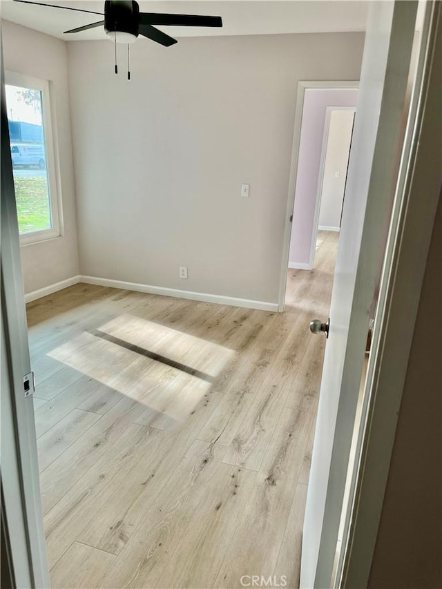 empty room with light hardwood / wood-style flooring and ceiling fan