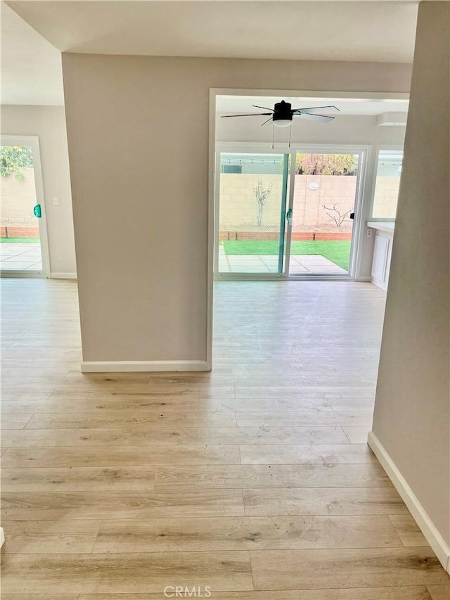 hallway with light hardwood / wood-style flooring