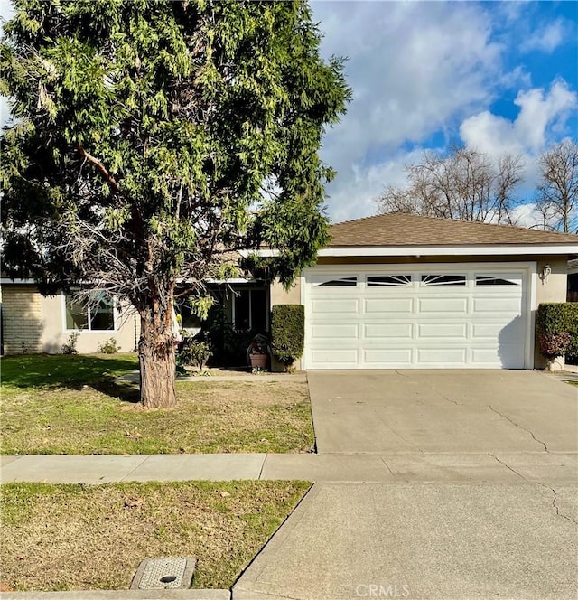 view of front of property with a garage and a front yard