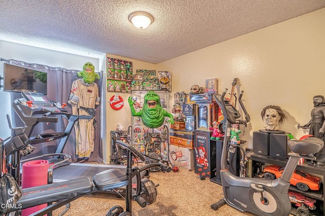 workout area featuring carpet floors and a textured ceiling