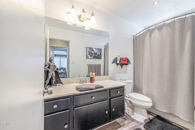 full bathroom with toilet, vanity, wood-type flooring, and shower / bathtub combination with curtain