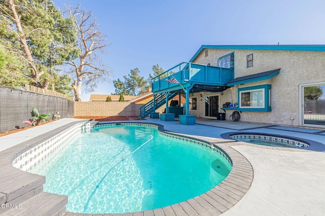 view of pool with a patio area and an in ground hot tub