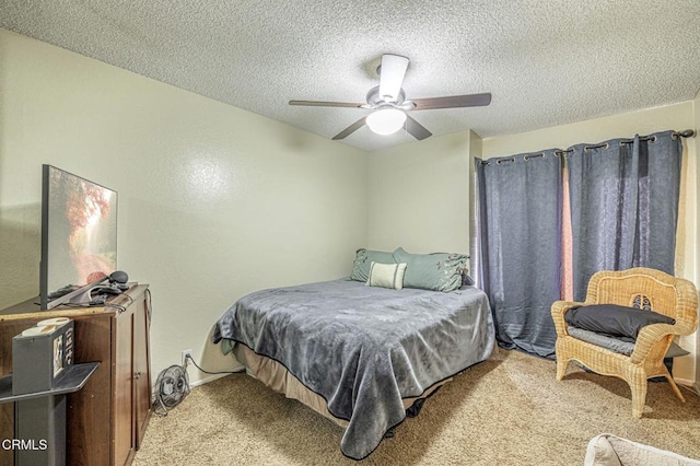 bedroom with a textured ceiling, a ceiling fan, and light colored carpet