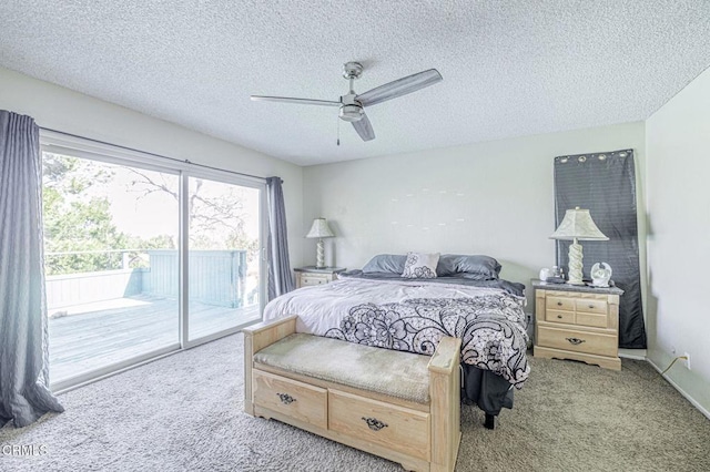 carpeted bedroom featuring access to exterior, a textured ceiling, baseboards, and a ceiling fan