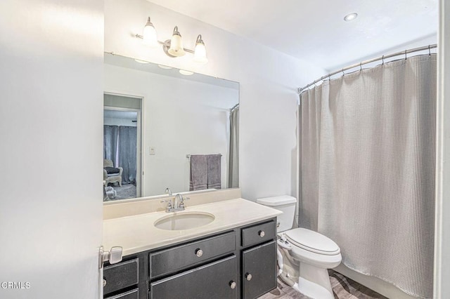 bathroom featuring toilet and vanity