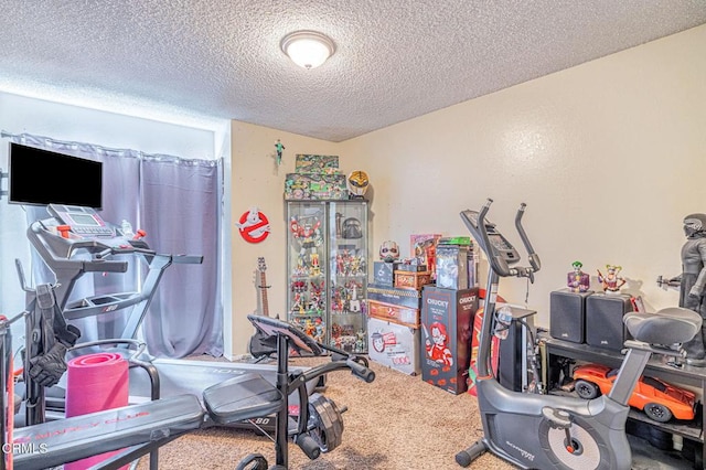 workout room with carpet floors and a textured ceiling