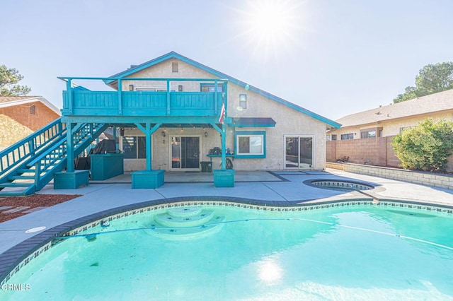 back of property featuring an outdoor pool, a patio, an in ground hot tub, stairs, and fence