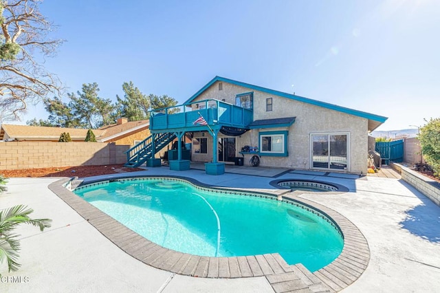 view of swimming pool featuring stairs, a fenced in pool, a fenced backyard, and an in ground hot tub