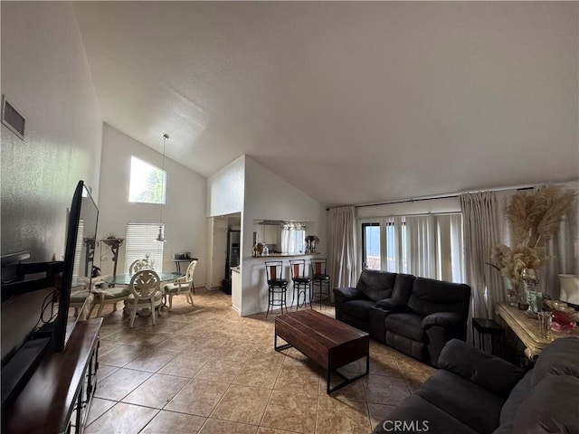 tiled living room with high vaulted ceiling